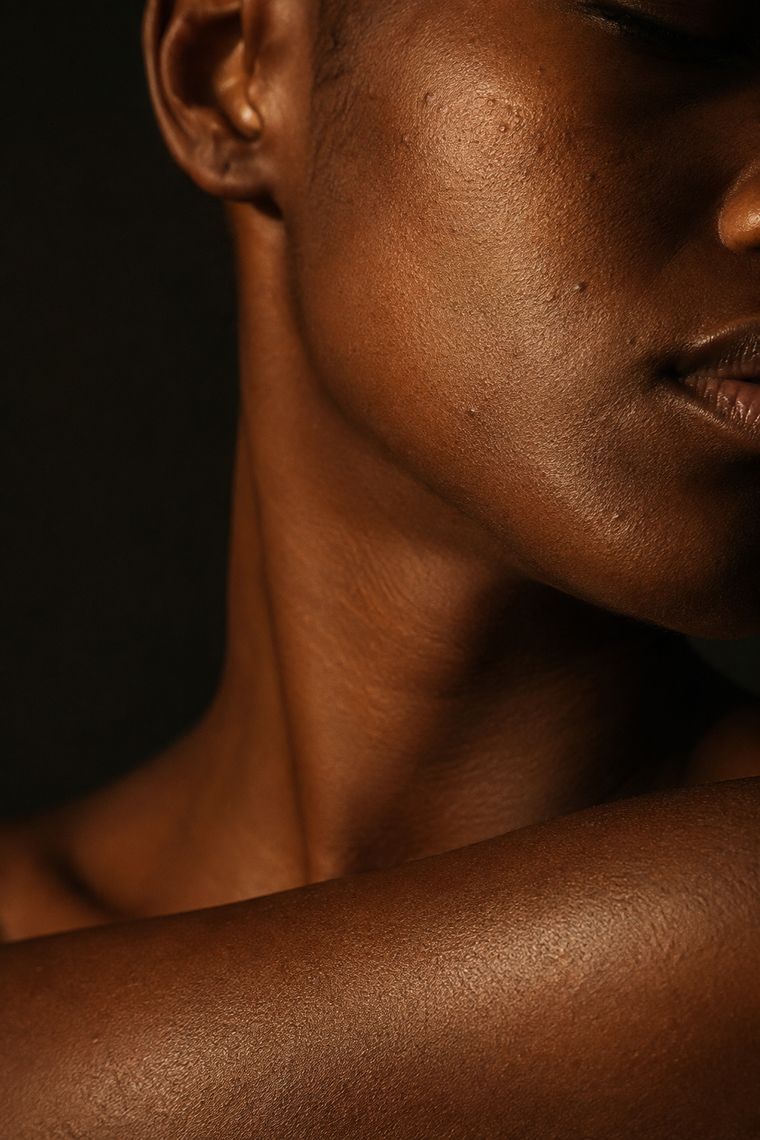 Skin texture and pigment across a jaw, neck and shoulder