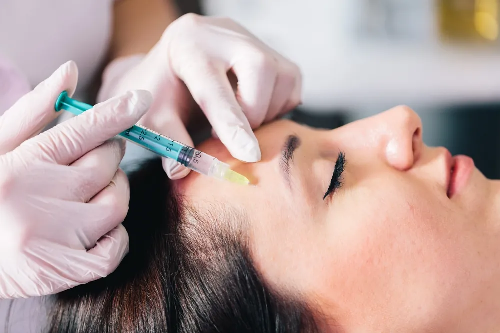 woman getting several units of Botox in her forehead in DC