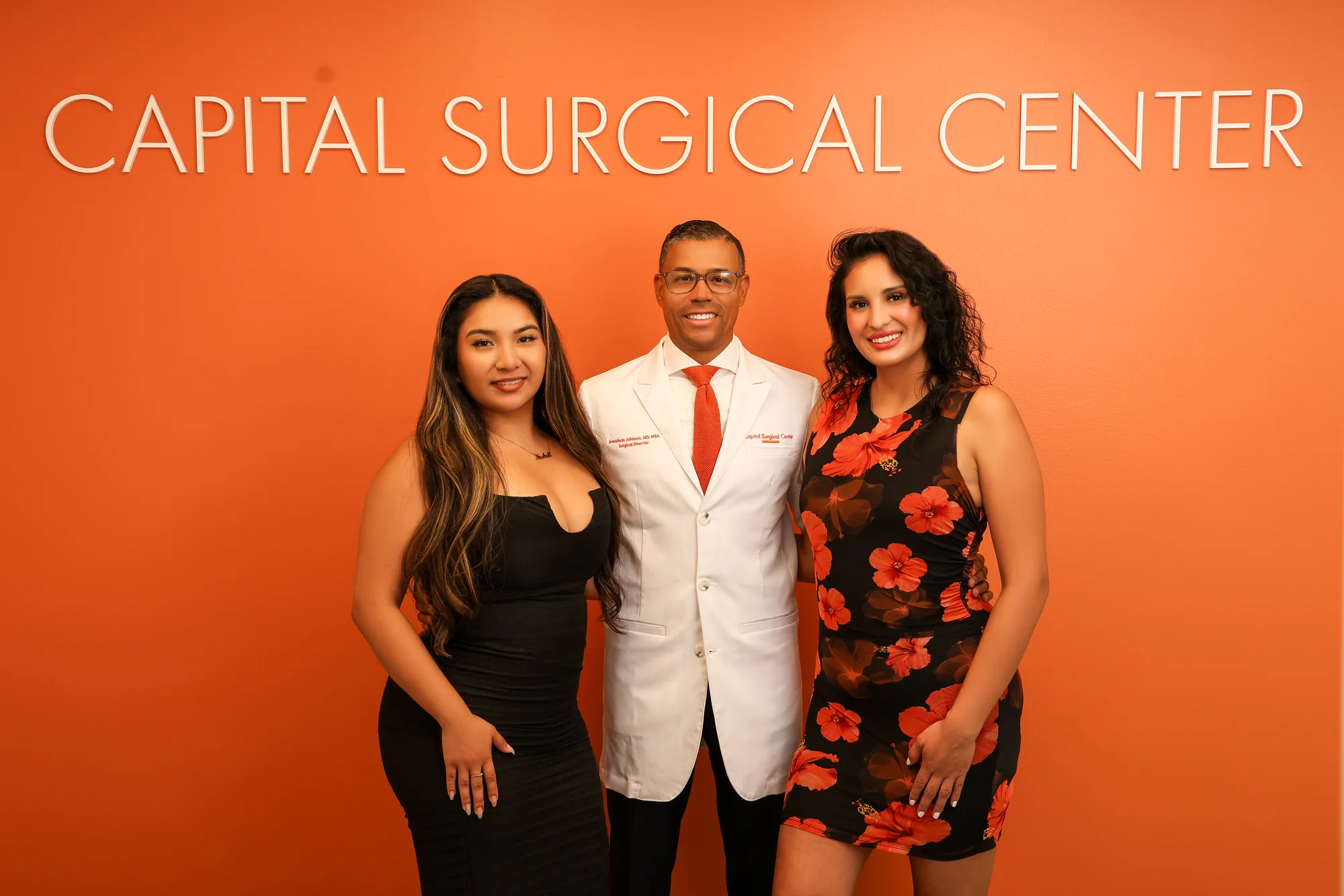 Jonathan Johnson, MD, MBA, CWSP, FAPWCA with the Capital Surgical Center team beneath the suite sign
